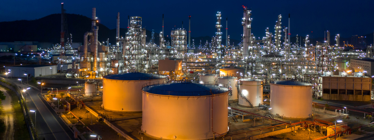 Aerial view. Oil refinery factory and oil storage tank at twilight and night. Petrochemical Industrial.